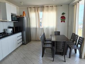 a kitchen with a table and chairs and a kitchen with a christmas ornament at VistamarGrau in Caleta Grau
