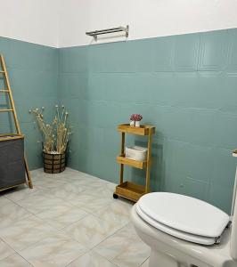 a bathroom with a toilet and a blue wall at Meu Quintal 4, Calheta-Madeira in Calheta +21 photos