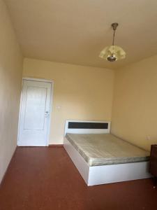 a bedroom with a bed and a white door at 2 Floor House with big garden and Mountain View in Bjni in Bjni