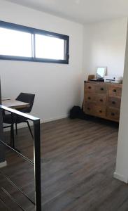 an office with a desk and a dresser in a room at Location maison confortable et cozi in Cazaux