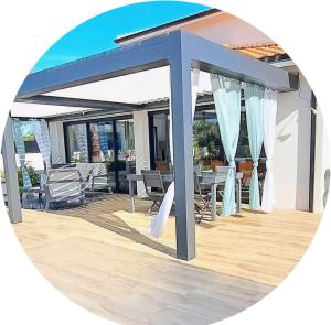 a circular picture of a patio with a blue pergola at Location maison confortable et cozi in Cazaux +5 photos