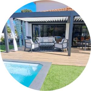a patio with chairs and a swimming pool at Location maison confortable et cozi in Cazaux