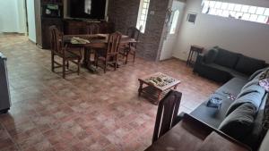a living room with a couch and a table and chairs at Complejo Casablanca Plottier in Plottier
