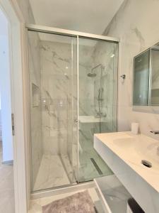 a bathroom with a shower and a sink at Rena Studios in Paleokastritsa