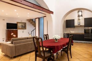 a living room with a table and a couch at Palazzo Barone in Bari