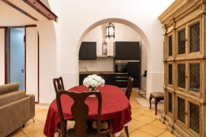 a kitchen and dining room with a table and chairs at Palazzo Barone in Bari +16 photos