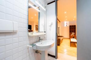 a bathroom with a sink and a mirror at Palazzo Barone in Bari