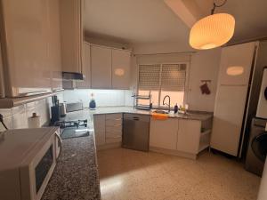 a kitchen with a sink and a stove top oven at Charming Home in Lorca Murcia in Lorca