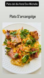 a white plate of pasta with meat and vegetables at Hotel Don Michele in Boca Chica