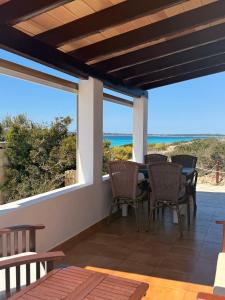 a patio with a table and chairs and the ocean at Apartamentos La Fragata in Es Arenals