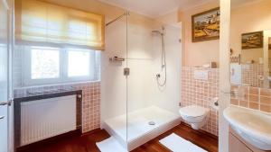 a bathroom with a shower and a toilet and a sink at Kaiser's Landhaus in Schliersee +21 photos