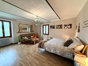 a bedroom with a bed and a living room at Monferrato Guest House - Casa Gabry in Bruno +117 photos