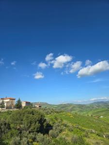 a view of a green field with a blue sky at Borgo Cipampini in Petralia Soprana