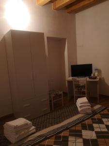 a living room with a dresser and a desk with a television at Borgo Cipampini in Petralia Soprana
