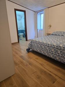 a bedroom with a bed and a wooden floor at Borgo Cipampini in Petralia Soprana