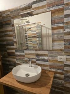 a bathroom with a sink and a mirror at Borgo Cipampini in Petralia Soprana