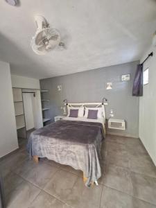a bedroom with a bed and a ceiling at BUNGALOWS COLIBRI in Las Galeras