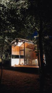 a house with two chairs and a table in front of it at Cabañas en Ribeira Sacra, Borbela de Luz in Villar de Ordelles +19 photos