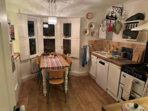 a kitchen with a table and a dining room at 64 Cressingham Road in London