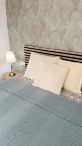 a bedroom with a bed with pillows and a lamp at Cortijo Sunny Duplex With Heated Pool & Terrace in Playa de las Americas in Playa de las Americas +18 photos
