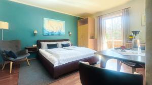 a bedroom with a bed and a desk and a chair at Kaiser's Landhaus in Schliersee