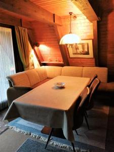 a living room with a table and a couch at Ferienhaus Im Abendrot in Waldbrunn +14 photos