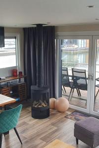 a living room with a fireplace with a view of the water at Floatinghouse Heaven on Earth in Klitten