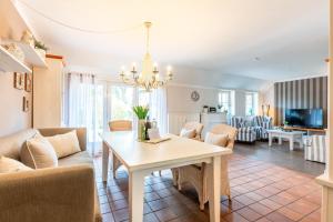 a dining room and living room with a table and chairs at Wrixum - Herrenhof Nr 7 Leevhüs in Wrixum
