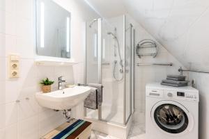 a bathroom with a sink and a washing machine at Wrixum - Herrenhof Nr 7 Leevhüs in Wrixum +44 photos