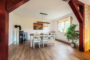 a dining room with a table and chairs and a fireplace at Waldnest Braunlage in Braunlage