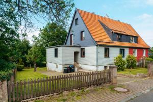a white house with an orange roof at Waldnest Braunlage in Braunlage