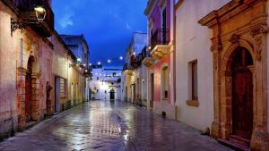 an empty street in an old town at night at Le Pozzelle Presicce, Bilocale Casa a Corte XVI sec in Presicce