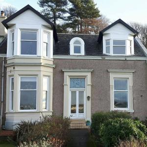 a house with white windows and a roof at Heaven Above the Haven in Millport