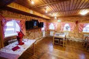 a room with a table and chairs in a house at House Liteyschika Nikulicheva with Banya in Suzdal