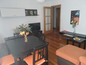 a living room with a table and chairs and a couch at La Casa de Lines in Monforte de Lemos