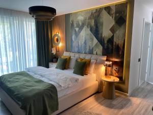 a bedroom with a bed with a large painting on the wall at Solaris Zenith View in Buşteni
