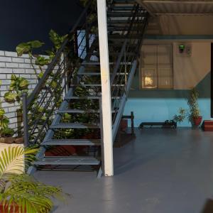 a staircase in a room with potted plants at OceanBliss_Homestay04 in Villupuram