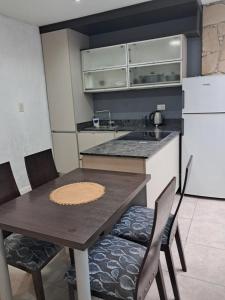 a kitchen with a table and chairs and a refrigerator at Residencial 43 in La Plata