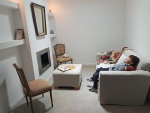 a young child sitting on a couch in a living room at Residencial 43 in La Plata