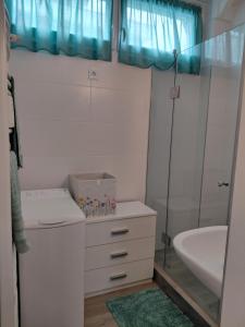 a bathroom with a sink and a toilet and a tub at Duna Kuckó in Mohács