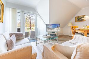 a living room with a couch and a table at Westmarkenpalais in Böhl