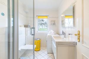 a white bathroom with a shower and a sink at Westmarkenpalais in Böhl +26 photos