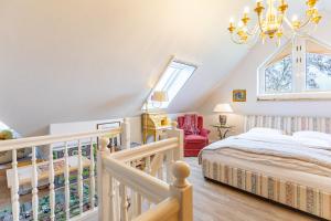 a bedroom with a bed and a staircase with a chandelier at Westmarkenpalais in Böhl
