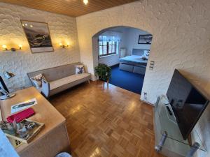 a living room with a couch and a bed at Landhotel Schönblick in Bad Herrenalb +94 photos