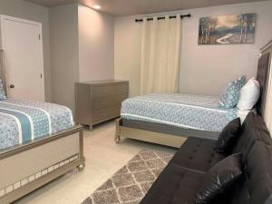 a living room with two beds and a couch at Woodrow St in Arlington +2 photos