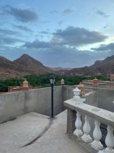 a street light on a ledge with mountains in the background at Red Rocks Guest House in Tamellalt
