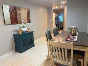 a dining room with a table and chairs and a table and a painting at Woodrow St in Arlington