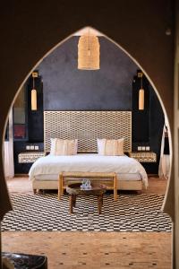 a bedroom with a bed and a coffee table at Riad Jawad & Spa in Marrakesh
