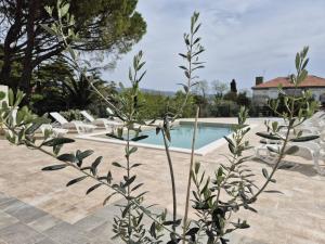 a resort with a swimming pool and some chairs at Natalija City 2 in Krk