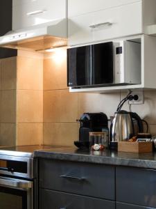 a kitchen with a counter top with a stove top oven at Apartman Riva Panoramska terasa & Privatna Garaža in Kraljevo +41 photos
